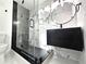 Modern bathroom features walk-in shower with black hardware and floating vanity at 21033 Market St, Dade City, FL 33523