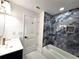 Bathroom boasts blue marble wall tile surrounding tub and gold hardware at 21033 Market St, Dade City, FL 33523