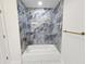 Bathroom showcasing tub with blue marble tiled surround and gold hardware at 21033 Market St, Dade City, FL 33523