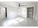 This bedroom includes marble floors, modern ceiling fan, and closet with shelving at 21033 Market St, Dade City, FL 33523
