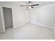 Spacious bedroom featuring a ceiling fan, closet, and stylish tile flooring at 21033 Market St, Dade City, FL 33523