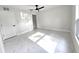 Bright, airy bedroom with marble floors, ceiling fan and closet at 21033 Market St, Dade City, FL 33523