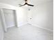 Bright bedroom featuring a ceiling fan, closet, and stylish tile flooring at 21033 Market St, Dade City, FL 33523