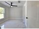 Bright bedroom boasts marble flooring, a modern ceiling fan, closet and natural light at 21033 Market St, Dade City, FL 33523