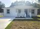 Inviting single-Gathering home with a covered porch, freshly painted, and modern design elements at 21033 Market St, Dade City, FL 33523