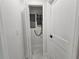 Hallway showcasing a tankless water heater and updated electrical panel at 21033 Market St, Dade City, FL 33523