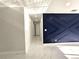 Hallway features white walls, marble tile floors, and a blue accent wall at 21033 Market St, Dade City, FL 33523