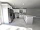 Stylish kitchen with white cabinetry, stone countertops, and stainless steel appliances offers ample counter space at 21033 Market St, Dade City, FL 33523