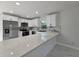 Well-equipped kitchen with sleek white cabinets, stainless steel appliances, and a functional island counter at 21033 Market St, Dade City, FL 33523