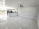 Open-concept living space with sleek white tile flooring and seamless transition to the modern kitchen at 21033 Market St, Dade City, FL 33523