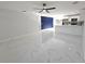 Bright and spacious living area with modern white tile flooring, custom accent wall, and open floorplan at 21033 Market St, Dade City, FL 33523