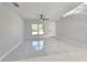 Open living room with lots of light and stylish modern tile flooring at 21033 Market St, Dade City, FL 33523