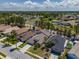 Aerial view of a home near palm trees and water with a two car garage at 2614 Hawk Roost Ct, Holiday, FL 34691
