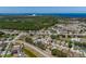 Community aerial view featuring lush greenery, water views and neighborhood homes with well-maintained landscapes at 2614 Hawk Roost Ct, Holiday, FL 34691