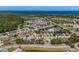 Expansive aerial view of the community with lush landscaping, coastal views, and neighborhood amenities at 2614 Hawk Roost Ct, Holiday, FL 34691