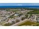 Breathtaking aerial view of the community, highlighting its proximity to the coast, lush greenery, and meticulously maintained homes at 2614 Hawk Roost Ct, Holiday, FL 34691