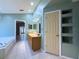 Large primary bathroom with double sinks, tile flooring, and separate shower and tub at 2614 Hawk Roost Ct, Holiday, FL 34691