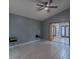 Spacious bedroom with fan, wall shelves, and light tile floors, perfect for relaxation at 2614 Hawk Roost Ct, Holiday, FL 34691