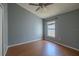This bedroom features wood flooring, neutral colored walls, and a ceiling fan at 2614 Hawk Roost Ct, Holiday, FL 34691