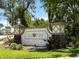 Elegant community sign reading 'Bay Point' with stone accents, lush greenery, and decorative lighting at 2614 Hawk Roost Ct, Holiday, FL 34691