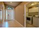 This entryway has a tiled floor with an arched window above the front door at 2614 Hawk Roost Ct, Holiday, FL 34691