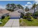 Inviting single-Gathering home with lush landscaping, two-car garage, and a well-kept lawn on a sunny day at 2614 Hawk Roost Ct, Holiday, FL 34691
