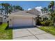 Charming single-Gathering home with a two-car garage, beautiful landscaping, and a well-maintained lawn at 2614 Hawk Roost Ct, Holiday, FL 34691