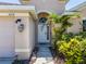 Inviting front entrance featuring an arched doorway, manicured landscaping, and a warm, welcoming ambiance at 2614 Hawk Roost Ct, Holiday, FL 34691