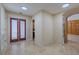 Inviting hallway with travertine floors, double doors, and seamless transition to other living spaces at 2614 Hawk Roost Ct, Holiday, FL 34691