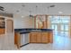 Open kitchen island featuring a stainless steel dishwasher and sink with tiled floors at 2614 Hawk Roost Ct, Holiday, FL 34691