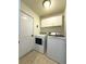 Bright laundry room features white cabinets and modern washer and dryer set at 2614 Hawk Roost Ct, Holiday, FL 34691