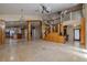 Spacious living room with a unique staircase and open layout to the kitchen at 2614 Hawk Roost Ct, Holiday, FL 34691