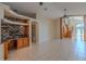 Spacious living room featuring tile flooring, built-in shelves, and staircase at 2614 Hawk Roost Ct, Holiday, FL 34691