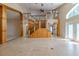 Open-concept living room features staircase with glass and wood elements at 2614 Hawk Roost Ct, Holiday, FL 34691