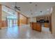 Open-concept living room and kitchen with tiled floors, high ceilings, and natural lighting at 2614 Hawk Roost Ct, Holiday, FL 34691