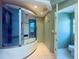 Spa-like main bathroom featuring a large jetted shower and neutral tile floors at 2614 Hawk Roost Ct, Holiday, FL 34691