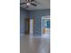 Open main bedroom featuring tile floors, gray walls, and a ceiling fan at 2614 Hawk Roost Ct, Holiday, FL 34691