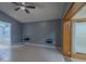 Open main bedroom featuring tile floors, gray walls, and a ceiling fan at 2614 Hawk Roost Ct, Holiday, FL 34691