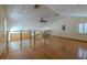 Upstairs room with hardwood floors, glass-paneled railing, and high ceilings at 2614 Hawk Roost Ct, Holiday, FL 34691