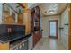 Wet bar with a wine fridge and dark wood cabinets, perfect for entertaining guests at 2614 Hawk Roost Ct, Holiday, FL 34691