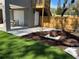 Backyard featuring artificial turf, a fire pit, and a quaint outdoor seating area at 2745 4Th S Ave, St Petersburg, FL 33712