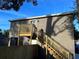 Exterior shot of a backyard and new deck with stairs leading up to a second story door at 2745 4Th S Ave, St Petersburg, FL 33712