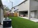 Expansive backyard with artificial grass, covered patio with living area, and privacy fence at 2745 4Th S Ave, St Petersburg, FL 33712