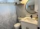 Bathroom with modern finishes, decorative mirror and shower curtain, and lots of light at 2745 4Th S Ave, St Petersburg, FL 33712