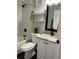 This bathroom features white cabinets, black hardware, and shower-tub combo at 2745 4Th S Ave, St Petersburg, FL 33712