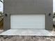 Image of newly installed white garage door, on gray concrete wall with exterior lighting at 2745 4Th S Ave, St Petersburg, FL 33712