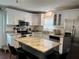 Renovated kitchen features a large island, stainless steel appliances, and modern white cabinets at 2745 4Th S Ave, St Petersburg, FL 33712