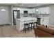Bright kitchen featuring white cabinets, stainless steel appliances, island with seating, and hardwood floors at 2745 4Th S Ave, St Petersburg, FL 33712