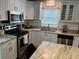 Bright kitchen with white cabinets, stainless appliances, granite countertops, and large island at 2745 4Th S Ave, St Petersburg, FL 33712