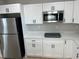 Well-lit kitchen featuring stainless steel appliances and modern white cabinetry with black hardware at 2745 4Th S Ave, St Petersburg, FL 33712